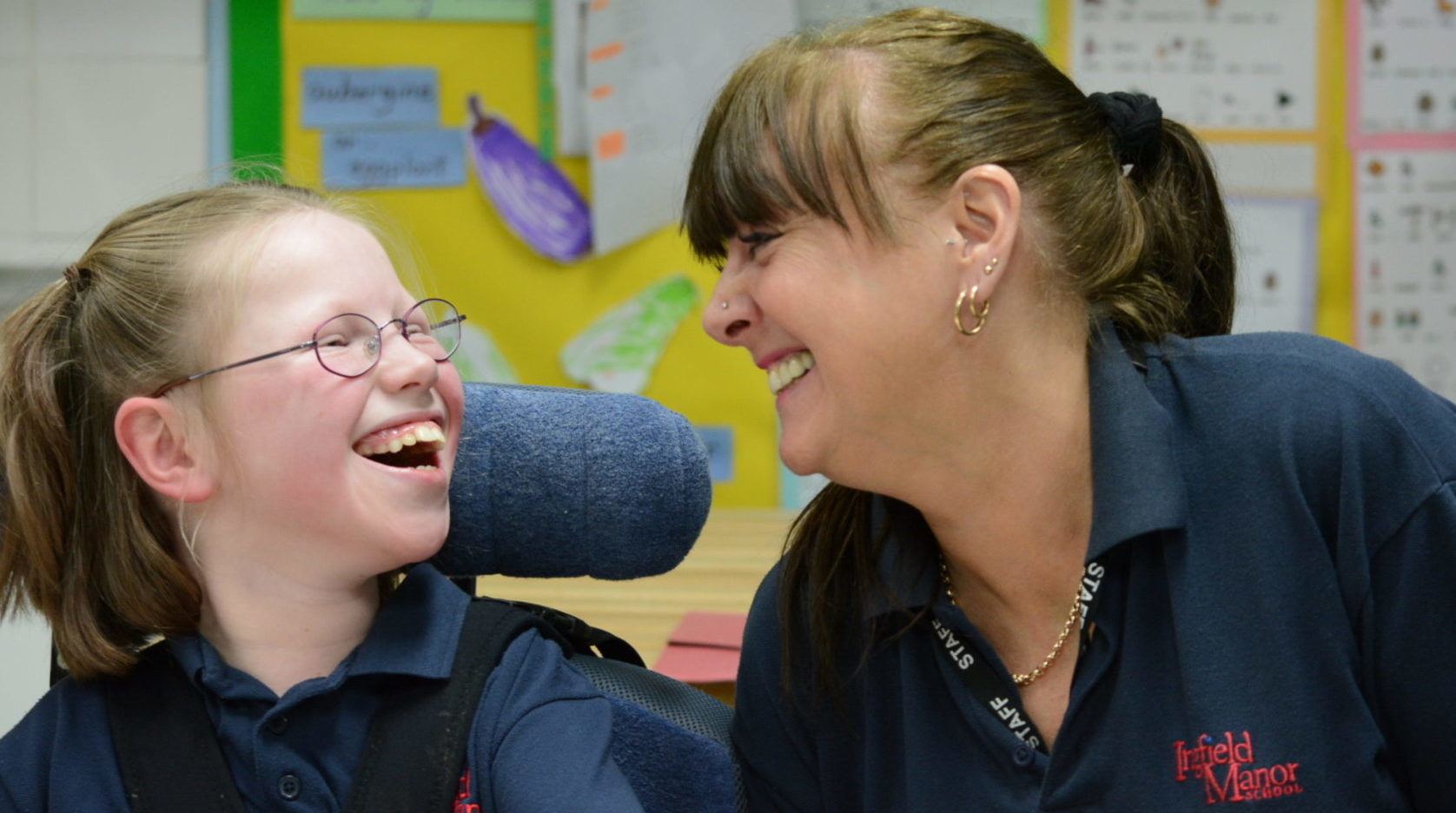 Support worker and a child sitting in a wheelchair