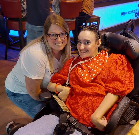 A support worker and a lady sitting in a wheelchair